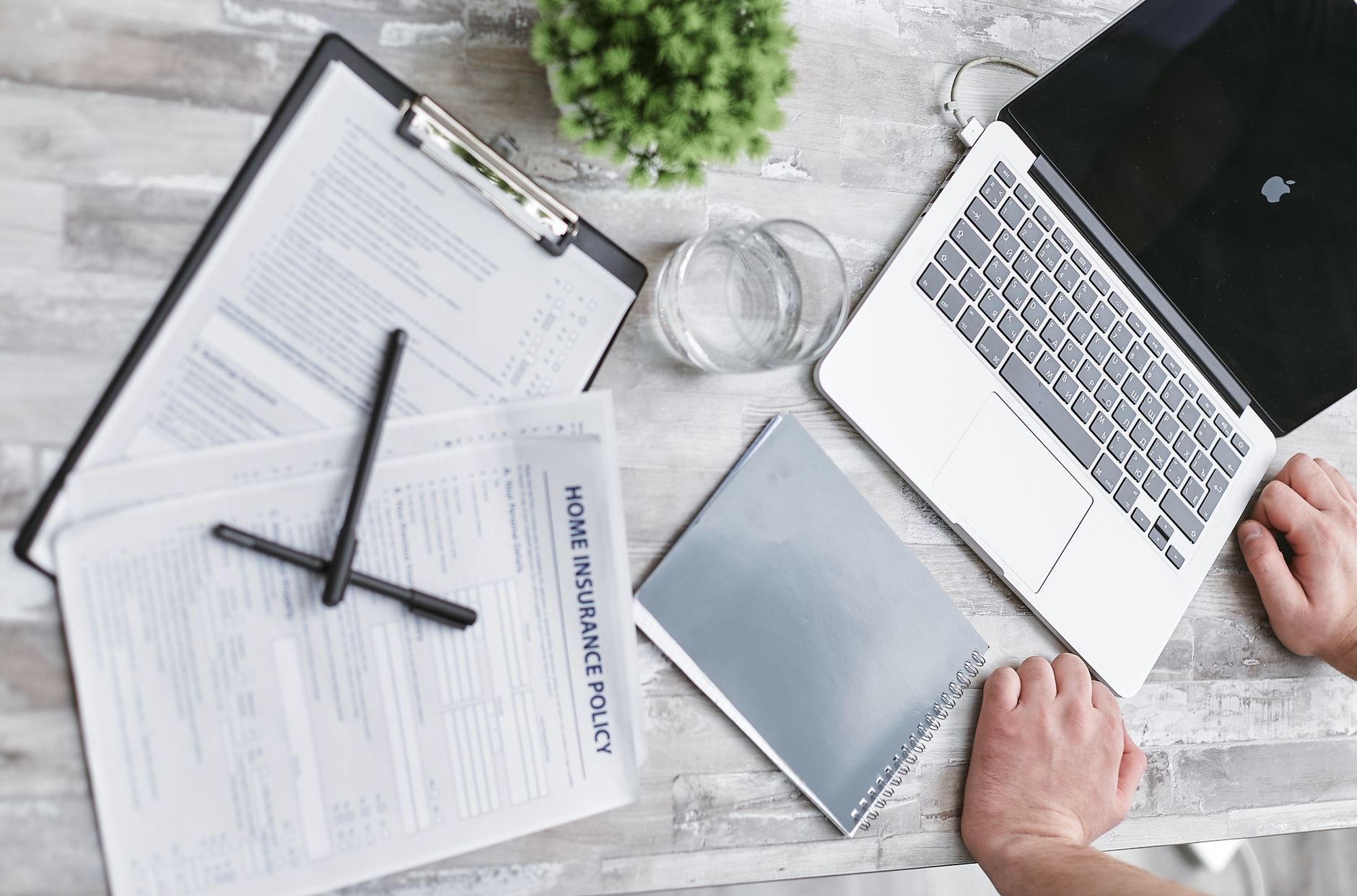 Whole life insurance policy documents and calculator on a desk